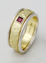 A three band wedding ring with Carré cut Ruby